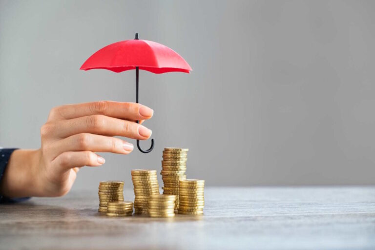 Regtech adoption shown by tiny umbrella over piles of coins