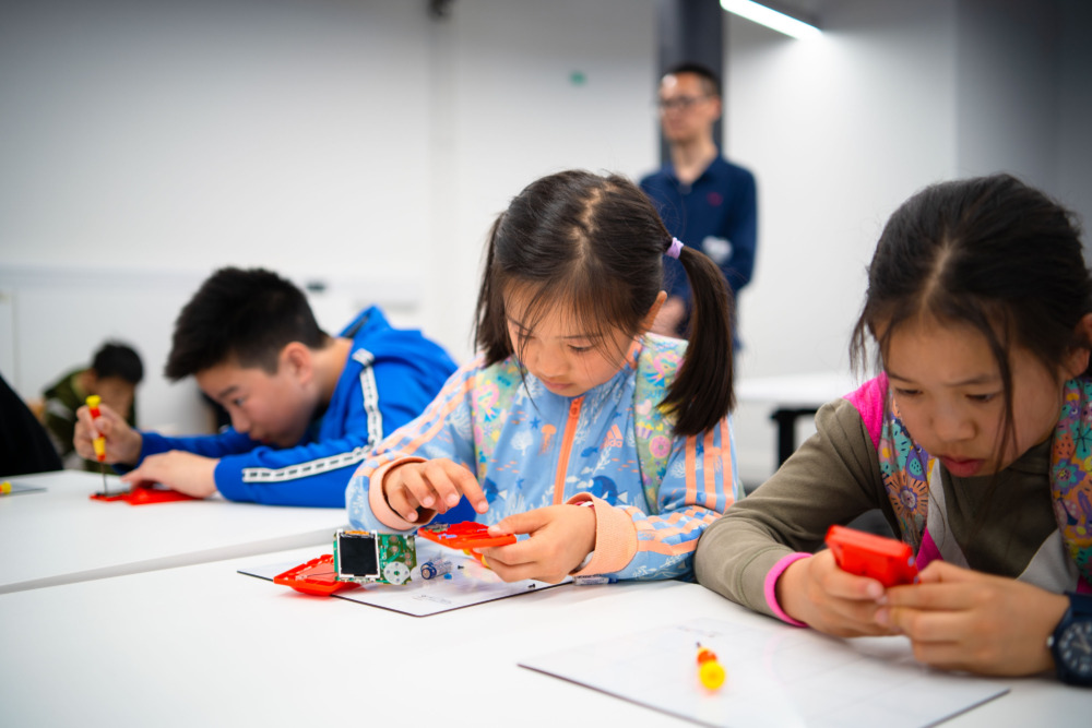 Image of three children fixing with Team Repair kits